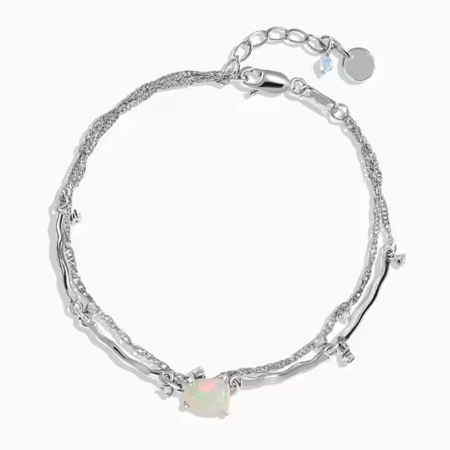 Charmables™ bracelets featuring raw crystal cuffs, celestial charm chains, and fidget-friendly designs in 18kt gold vermeil and sterling silver. Designed for stacking, swapping, and personalization with interchangeable charms.